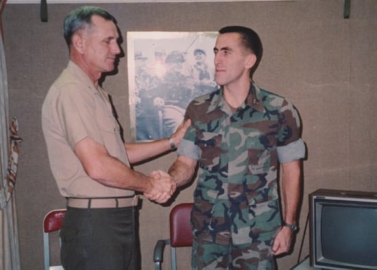 Matthew J. Baker shaking hands with a soldier